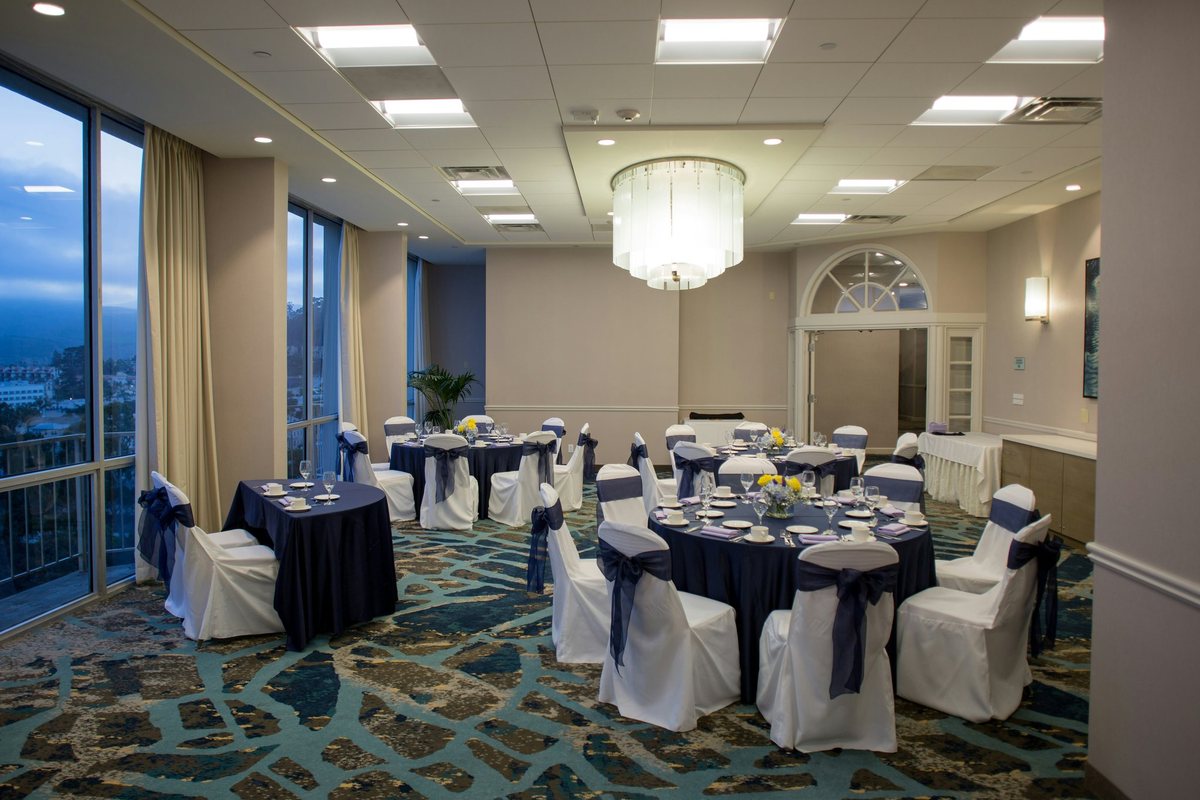 The Bay View room at Crowne Plaza Ventura Beach set for a banquet beside ocean-view windows