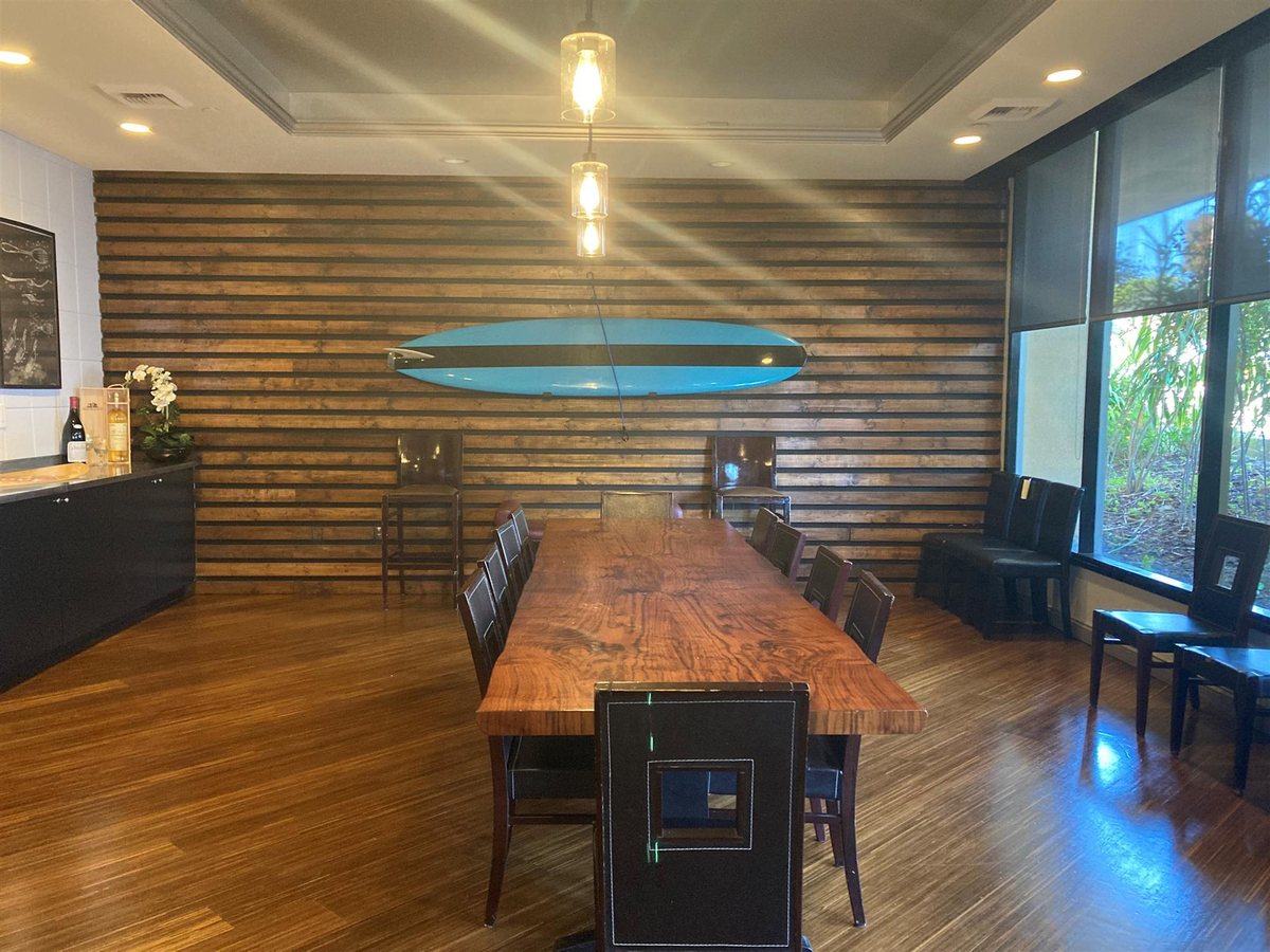 The Chef's Table room at Crowne Plaza Ventura Beach with a long table and wood-panel wall