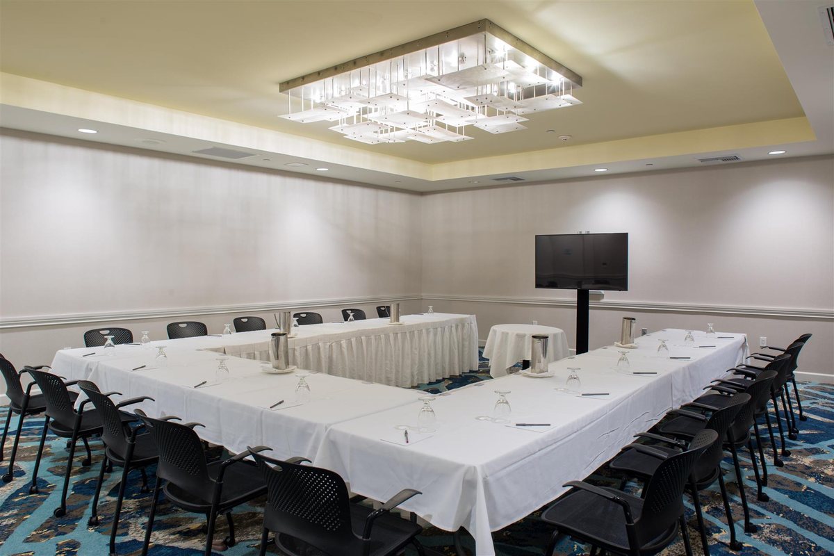 The Santa Cruz room at Crowne Plaza Ventura Beach set U-shape with a wall display