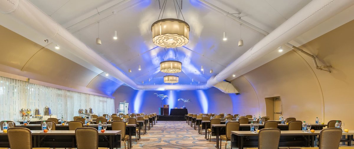 The Gallery at DoubleTree San Diego Mission Valley set classroom style under chandeliers