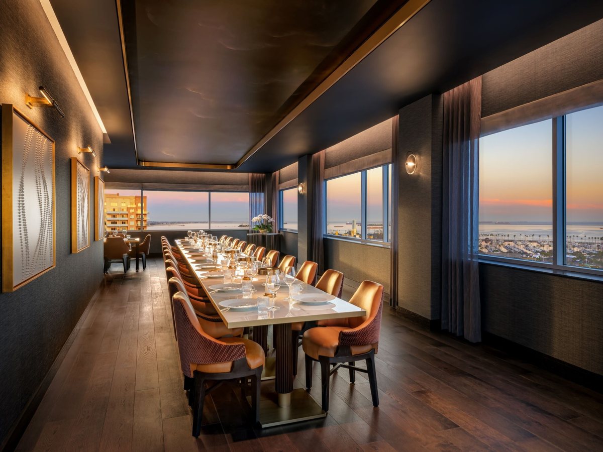 Sky Room West at Fairmont Breakers Long Beach with a long dinner table by the windows