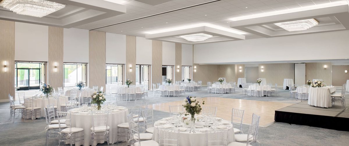 The ballroom at Hilton Los Angeles Culver City set with round tables for a wedding