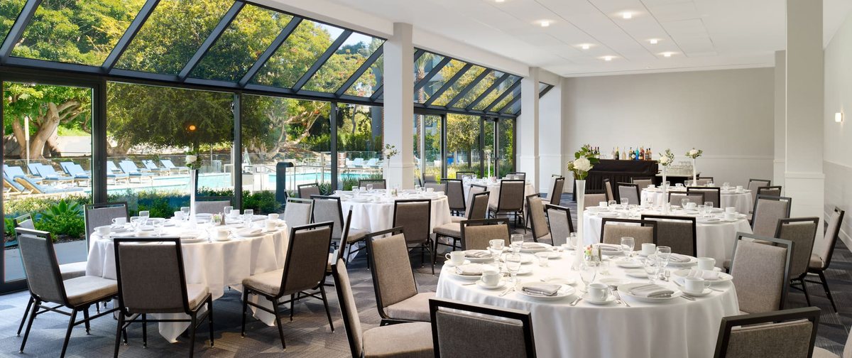The Catalina room at Hilton Los Angeles Culver City set with round tables