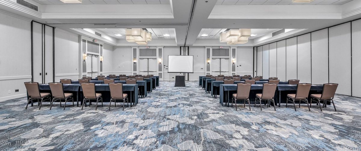 The Del Mar Ballroom at Hilton San Diego/Del Mar set classroom style facing a podium and projection screen