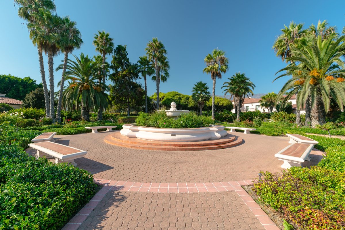 The Rose Garden at Hilton Santa Barbara Beachfront Resort with a fountain and palm trees