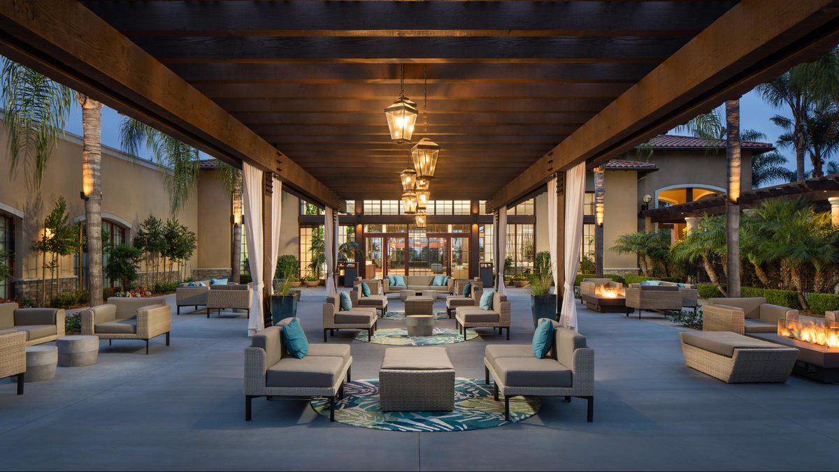 The Palm Courtyard at Hotel Solea at dusk with lounge seating and lanterns