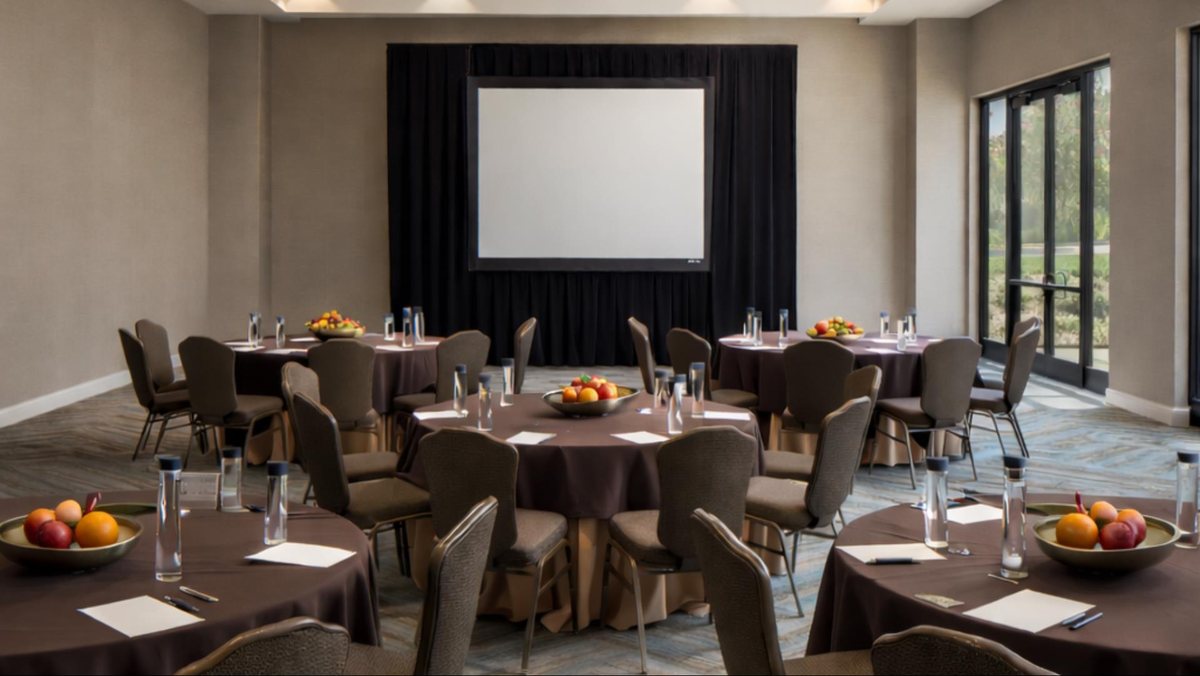 The Terramar Ballroom at Hotel Solea with round tables facing a projection screen