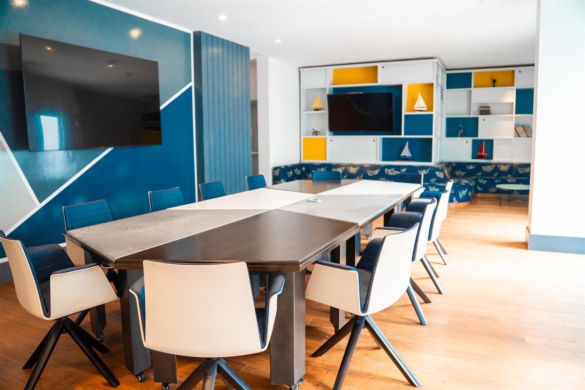 The Maritime room at Hyatt Centric The Pike Long Beach with a conference table and a wall display