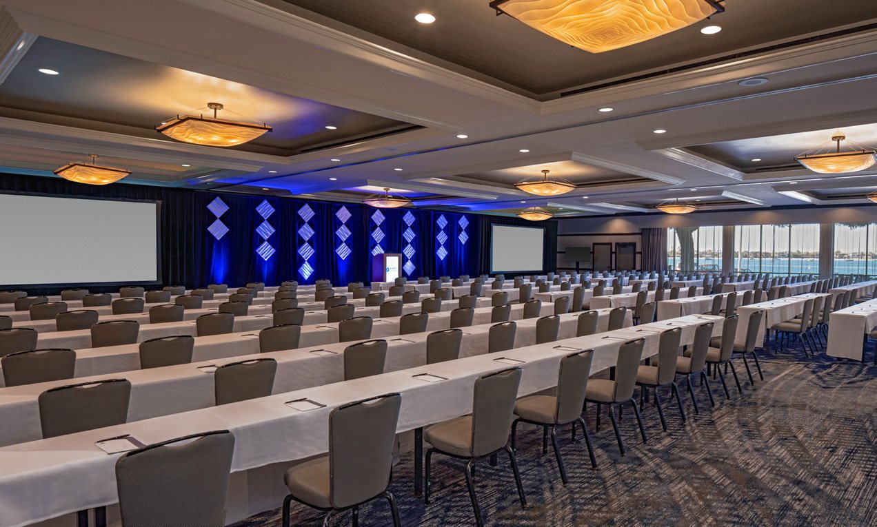 A ballroom at Hyatt Regency Mission Bay set theater style facing a stage and screens