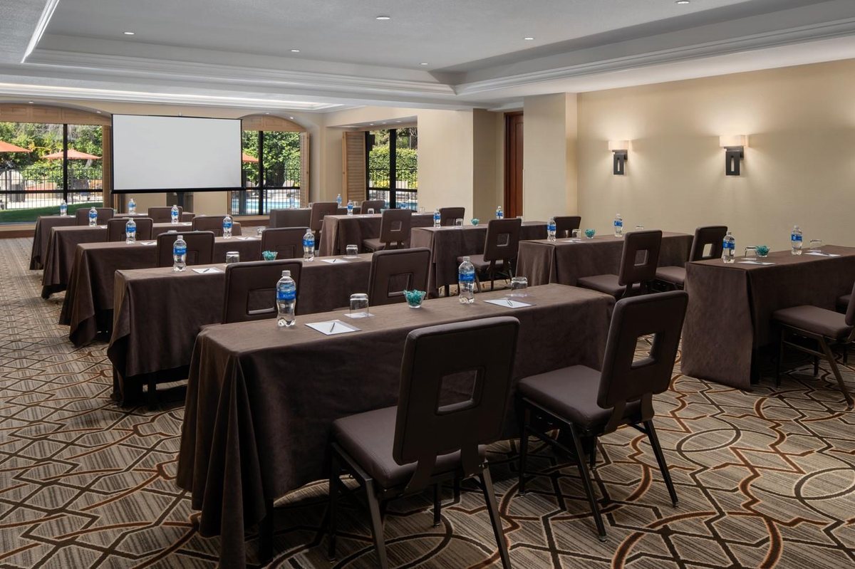 The Vista Ballroom at Hyatt Regency Westlake set classroom-style beside tall windows