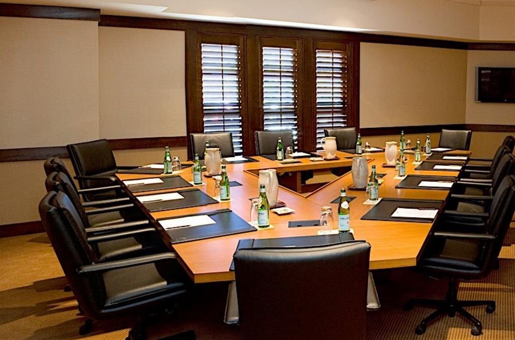 The Pinnacle Boardroom at Lake Arrowhead Resort and Spa with a long table and leather chairs