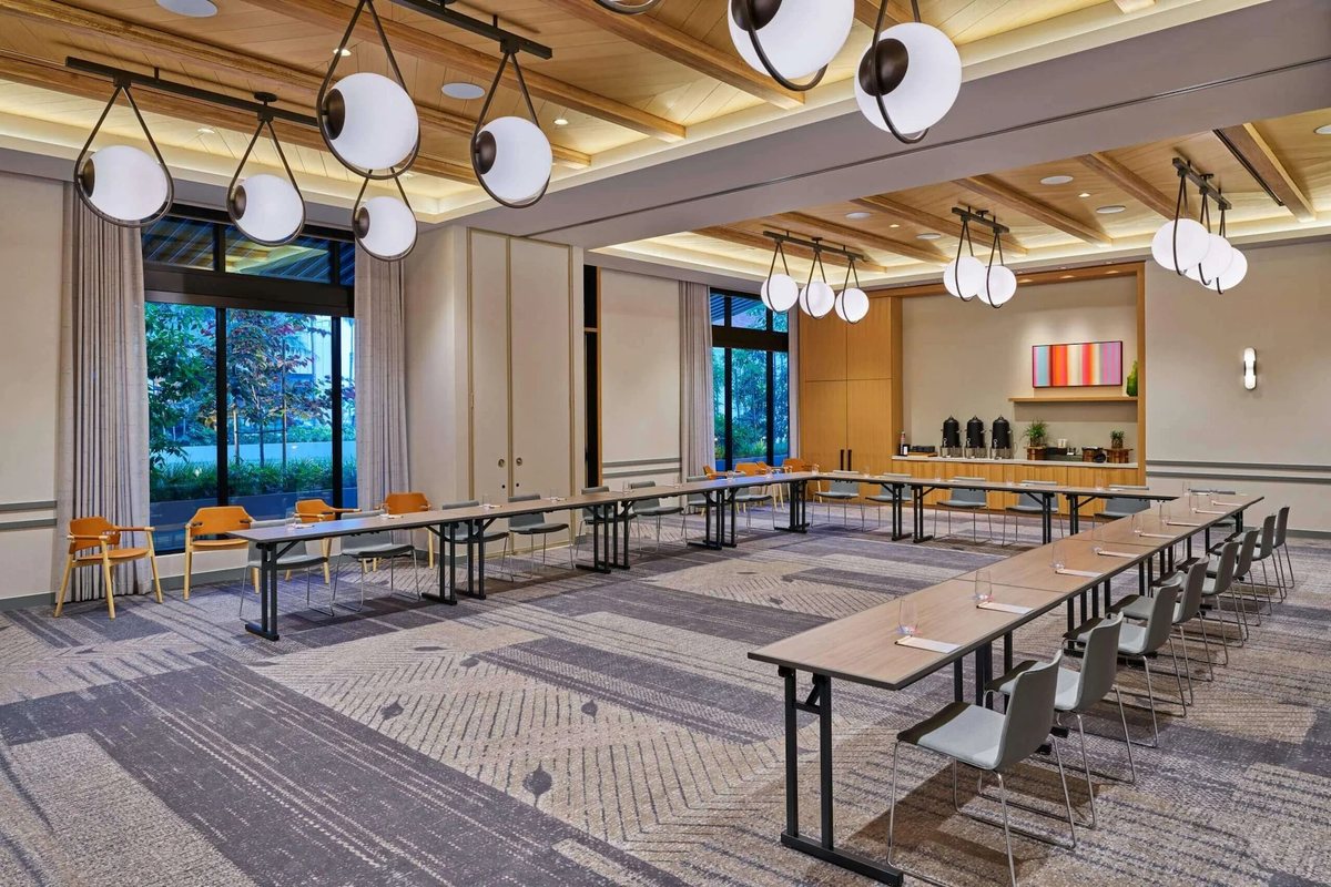 Shortboard at Mission Pacific Beach Resort set U-shape under globe pendant lights with garden windows