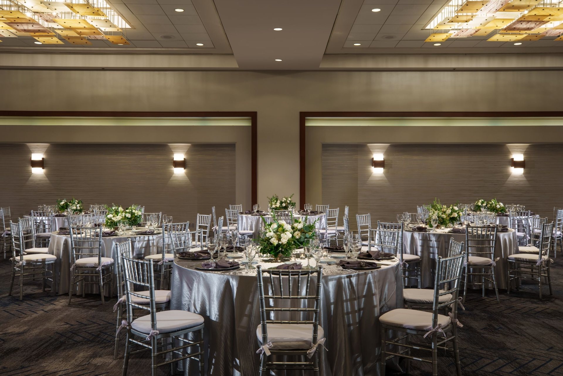 The Renaissance Ballroom set for dinner with round tables and gray chairs