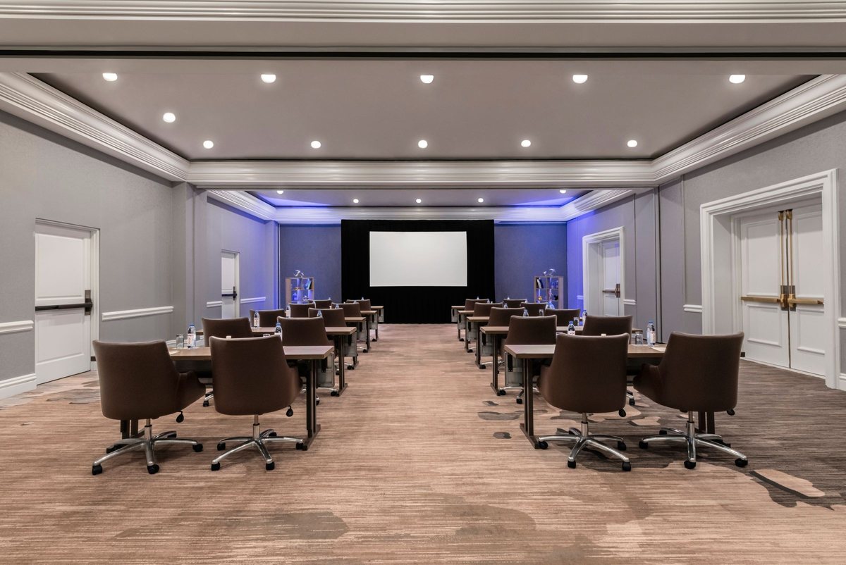 The Sequoia Ballroom at Renaissance Newport Beach Hotel set classroom style facing a screen with blue uplighting