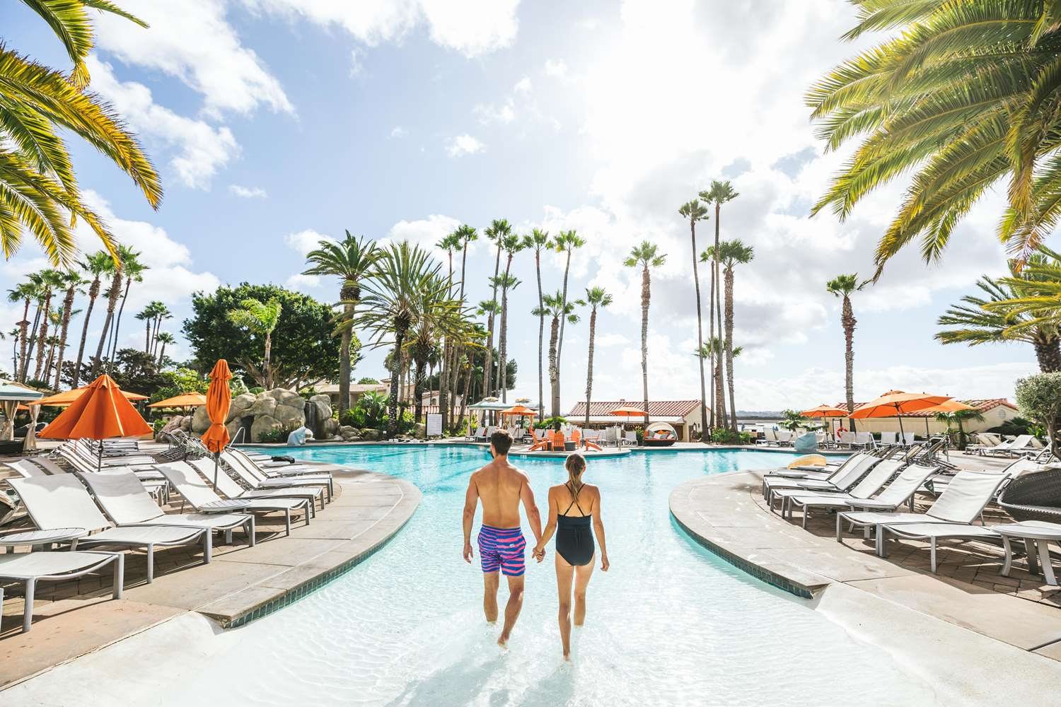 The pool at San Diego Mission Bay Resort lined with palm trees and cabanas