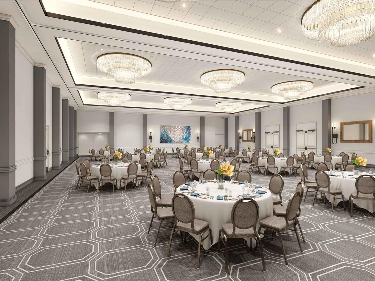 The International Ballroom at San Diego Mission Bay Resort set with round tables under chandeliers
