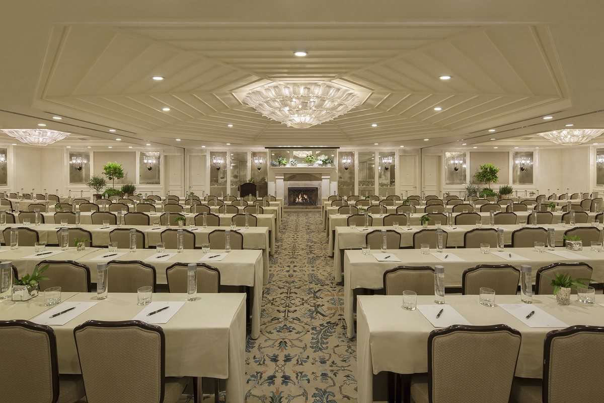 The Grand Salon set classroom style beneath chandeliers