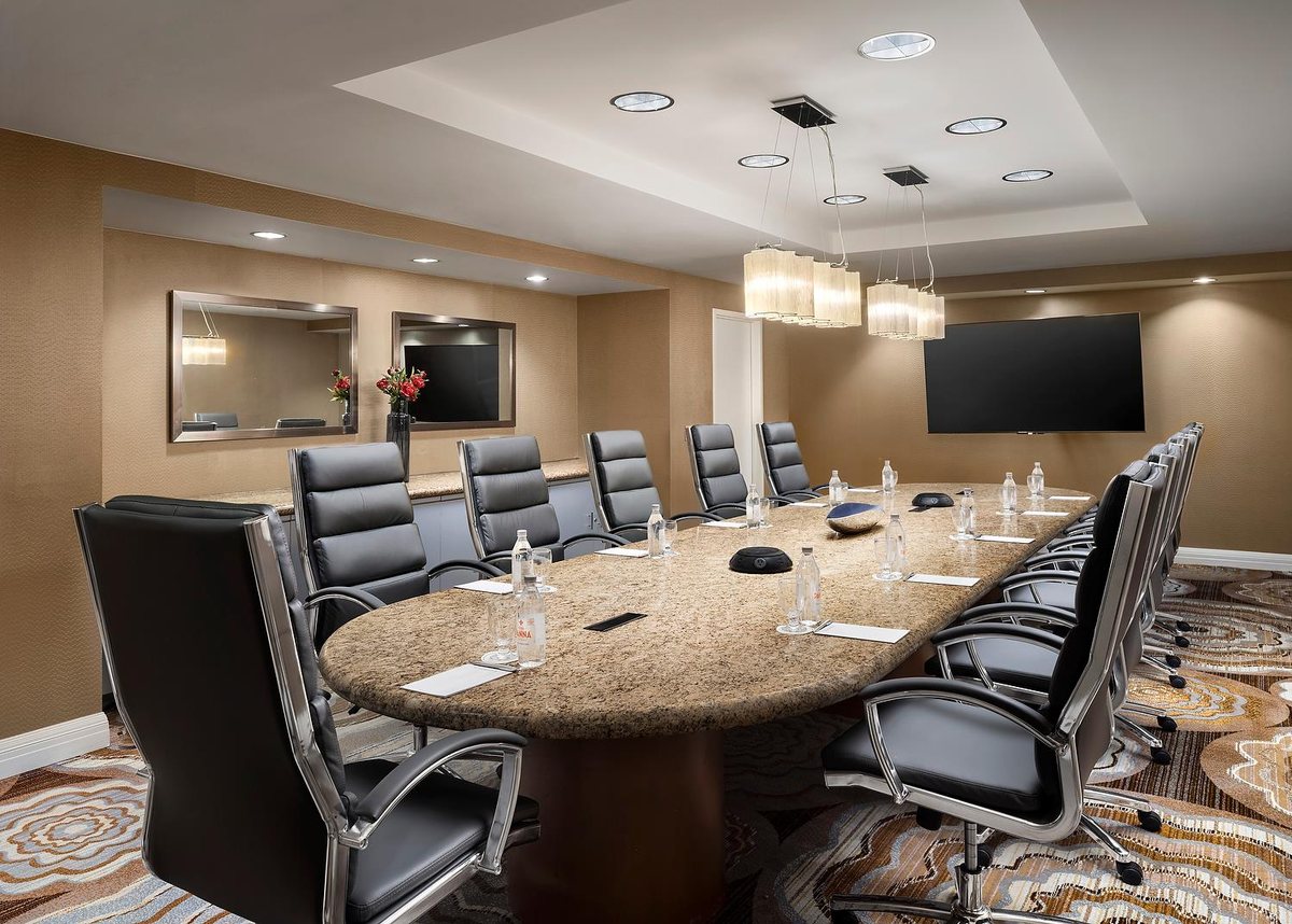 The Executive Boardroom at Sonesta Redondo Beach & Marina with a granite-top table and ergonomic chairs