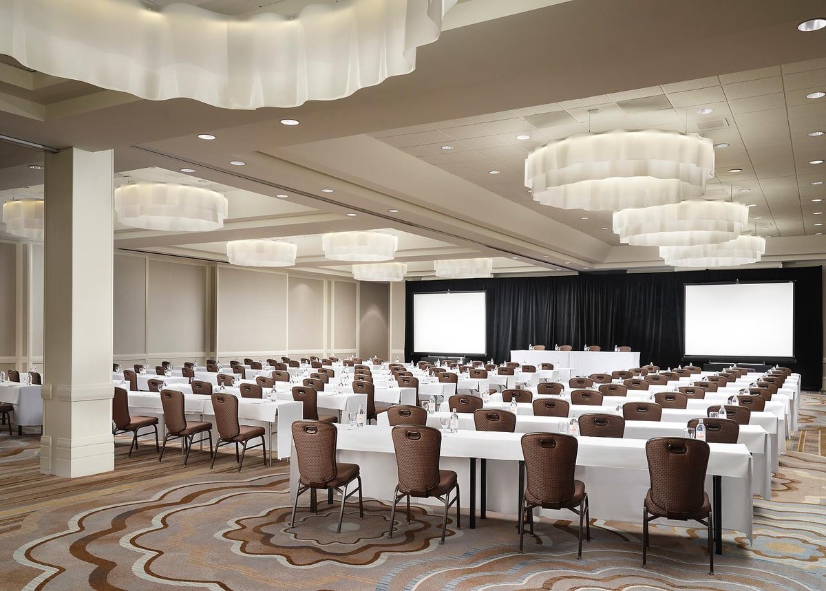 The Coral Ballroom at Sonesta Redondo Beach & Marina set theater-style under ribbon chandeliers