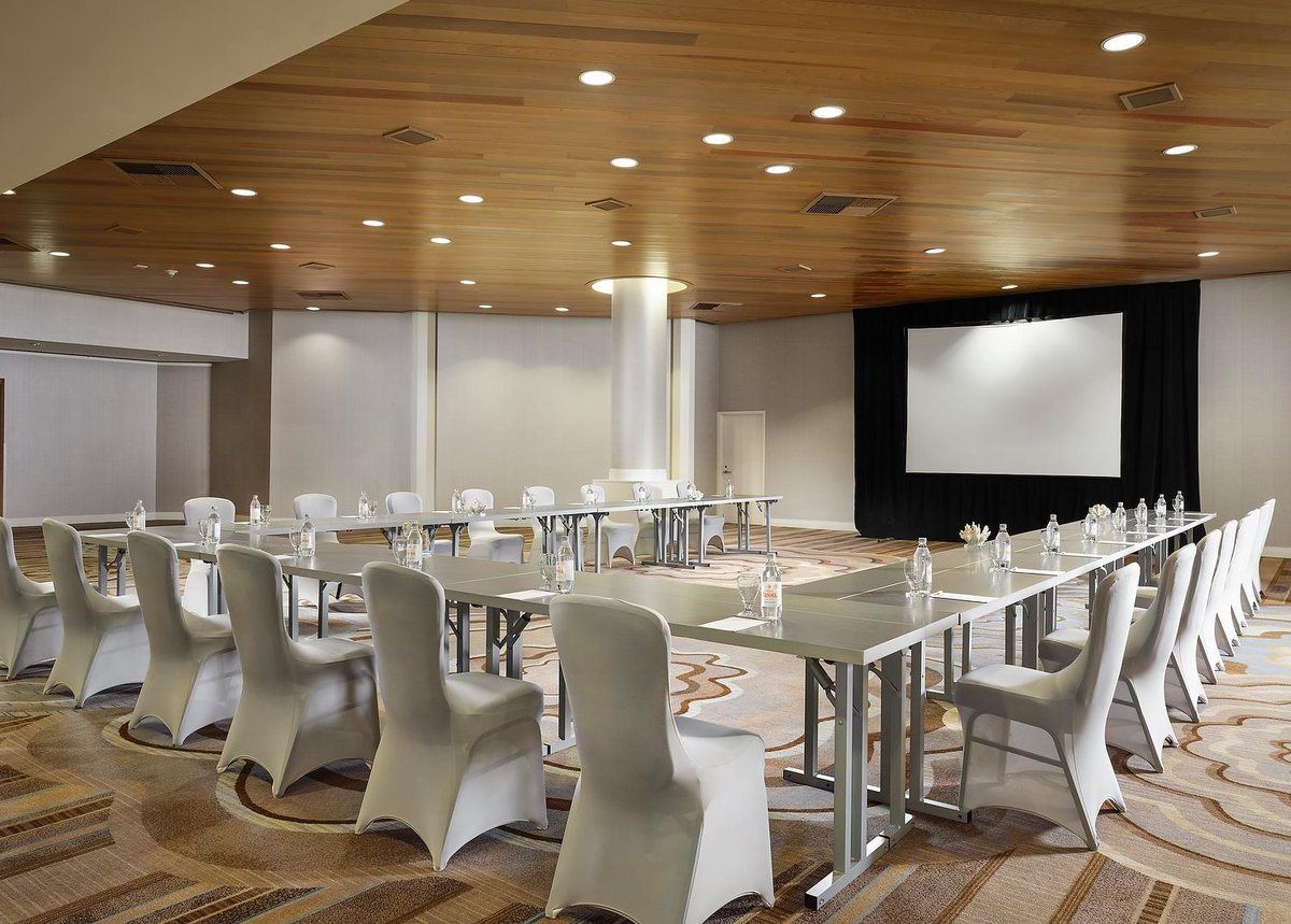 The Seascape Ballroom at Sonesta Redondo Beach & Marina set with long tables under a planked-wood ceiling