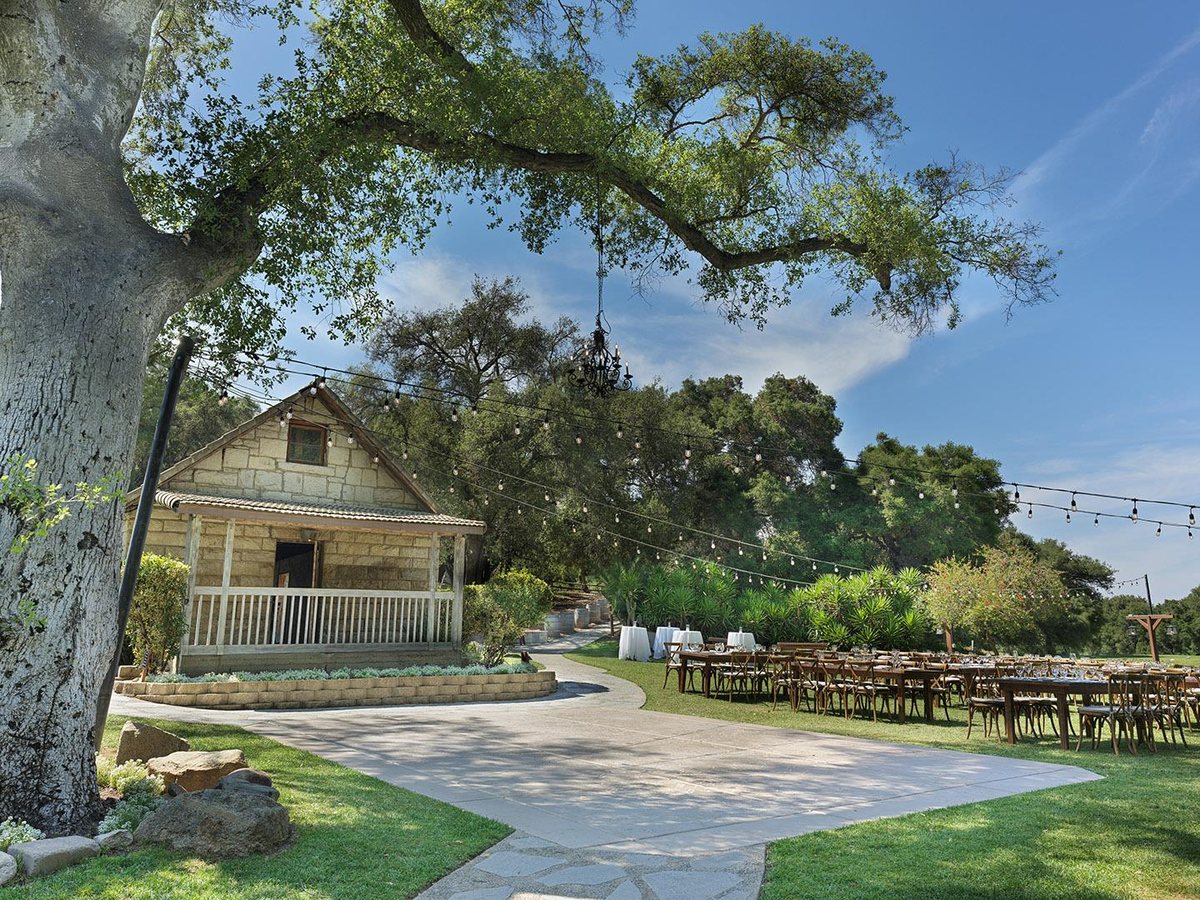 The historic Stone House at Temecula Creek Inn under oak trees