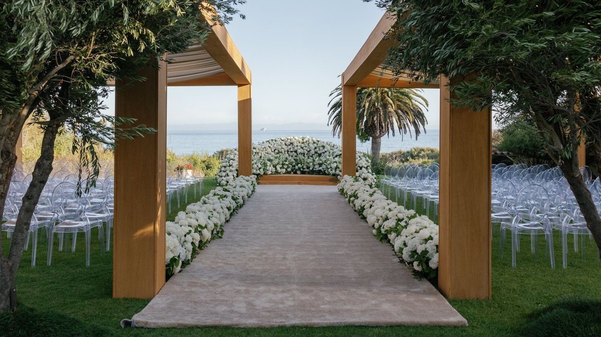 A flower-lined aisle leading to an arbor on The Bluff above the ocean