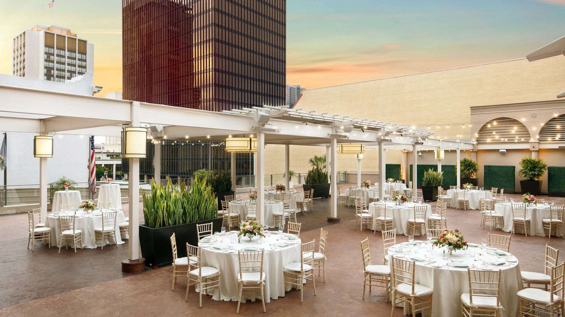 Round tables set on the Garden Terrace at The Westin San Diego Gaslamp Quarter at sunset