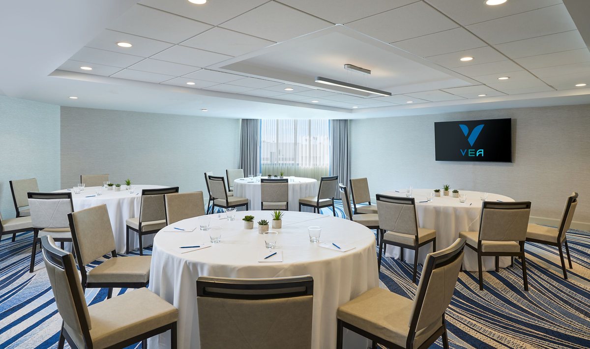 Carmel set with round tables and a wall display