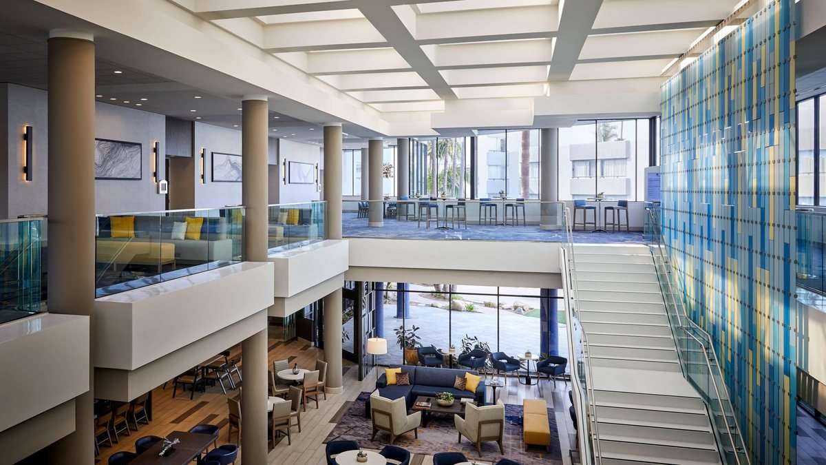 The pre-function Mezzanine at Ventura Beach Marriott with lounge seating and a staircase to the lobby